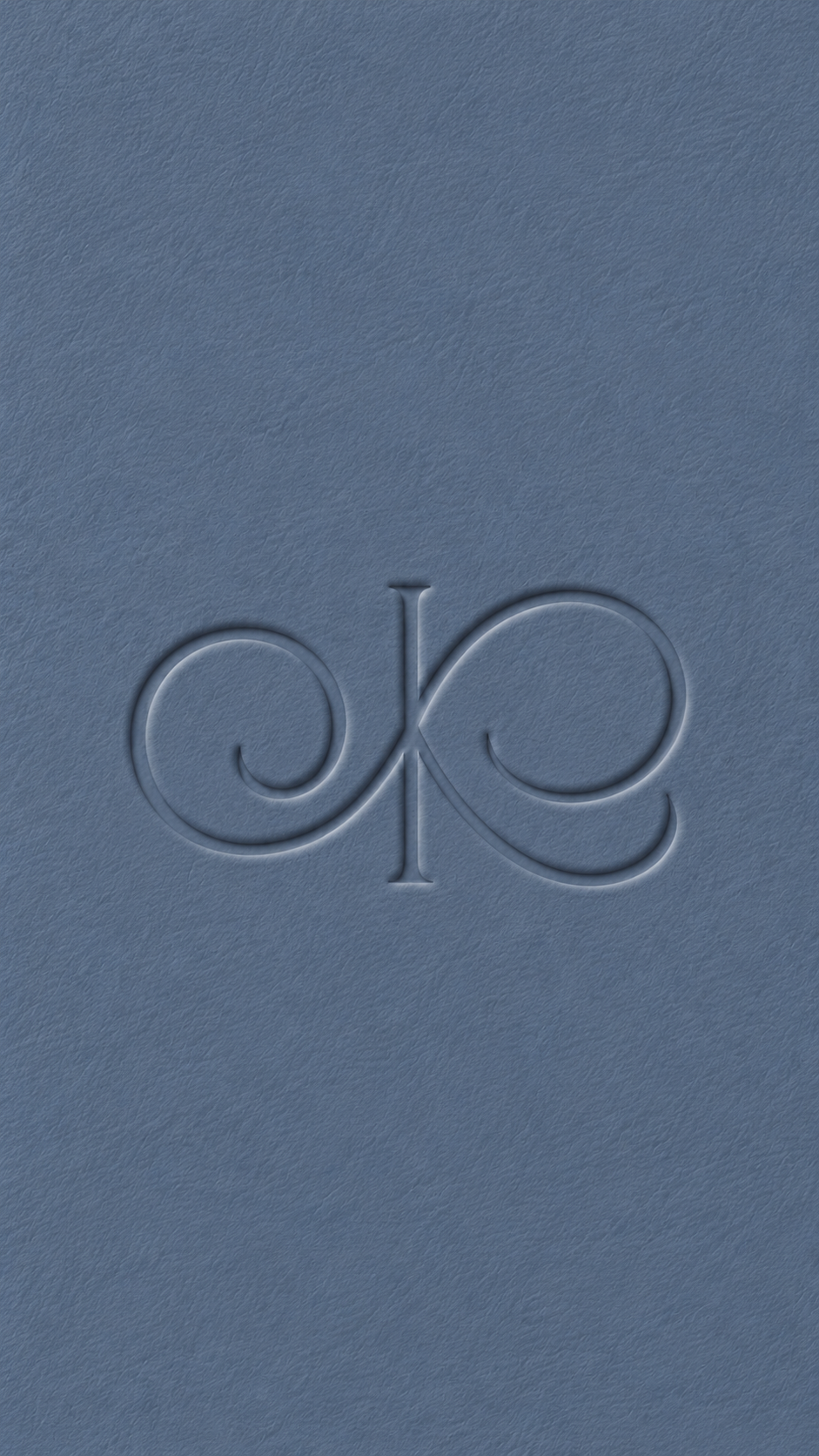 Embossed O and K monogram on blue textured paper